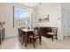A formal dining room with chandelier and view of tropical landscaping at 18652 Ohara Dr, Port Charlotte, FL 33948
