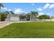 Charming single-story home with a well-manicured lawn and lush landscaping at 18652 Ohara Dr, Port Charlotte, FL 33948