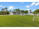 Charming single-story home with a well-manicured lawn and lush landscaping at 18652 Ohara Dr, Port Charlotte, FL 33948