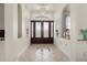 Inviting entryway with tiled floors, an elegant chandelier, and a decorative front door at 18652 Ohara Dr, Port Charlotte, FL 33948
