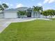 Charming single-story home with lush green lawn, rock landscaping, and well-maintained exterior at 18652 Ohara Dr, Port Charlotte, FL 33948
