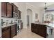 A kitchen with stainless steel appliances and dark wood cabinetry provides a lovely cooking space at 18652 Ohara Dr, Port Charlotte, FL 33948