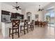 Open kitchen with eat-in bar and stainless steel appliances looking into the dining area at 18652 Ohara Dr, Port Charlotte, FL 33948