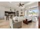 Comfortable living room with tile floors, a ceiling fan, and access to the kitchen and lanai at 18652 Ohara Dr, Port Charlotte, FL 33948