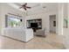 Bright and airy living room with tile floors, entertainment center, and access to a screened lanai at 18652 Ohara Dr, Port Charlotte, FL 33948