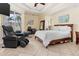 Spacious bedroom with slider access to pool, featuring a massage chair and modern décor at 18652 Ohara Dr, Port Charlotte, FL 33948