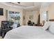 Spacious bedroom with slider access to pool, featuring a massage chair and modern décor at 18652 Ohara Dr, Port Charlotte, FL 33948