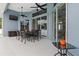 Covered patio with outdoor dining set, ceiling fans, and access to the interior through sliding glass doors at 18652 Ohara Dr, Port Charlotte, FL 33948