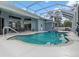 Inviting screened-in pool area with covered seating, ideal for relaxation and outdoor entertaining at 18652 Ohara Dr, Port Charlotte, FL 33948