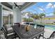 Covered patio with outdoor dining set overlooking the pool and spa area at 18652 Ohara Dr, Port Charlotte, FL 33948