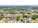 Wide aerial view showcasing the canal-front property with lush surroundings in a peaceful neighborhood at 18753 Klingler Cir, Port Charlotte, FL 33948