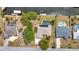 Aerial view of waterfront homes with boat docks and private pools, nestled in a green, canal-lined community at 18753 Klingler Cir, Port Charlotte, FL 33948