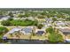 A beautiful aerial view of canal-front homes with private pools and docks, surrounded by lush greenery at 18753 Klingler Cir, Port Charlotte, FL 33948