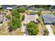 Aerial view of a well-maintained home with pool and solar panels, surrounded by lush landscaping at 18753 Klingler Cir, Port Charlotte, FL 33948