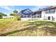 Backyard view of a screened pool enclosure, deck area, and grassy yard at 18753 Klingler Cir, Port Charlotte, FL 33948