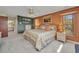 Comfortable bedroom with a ceiling fan, natural light and wicker furniture. View of the en-suite bathroom at 18753 Klingler Cir, Port Charlotte, FL 33948