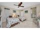 Bedroom featuring two twin beds, ceiling fan, and white wicker furniture at 18753 Klingler Cir, Port Charlotte, FL 33948