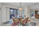 Dining area with a glass table, four rattan chairs, rug, and sliding glass doors at 18753 Klingler Cir, Port Charlotte, FL 33948