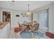Dining area with a glass table, four rattan chairs, rug, and sliding glass doors at 18753 Klingler Cir, Port Charlotte, FL 33948