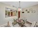 Dining room featuring a glass table, four rattan chairs, and vintage chandelier at 18753 Klingler Cir, Port Charlotte, FL 33948