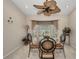 Dining room features a round table, four chairs, large window, and overhead ceiling fan at 18753 Klingler Cir, Port Charlotte, FL 33948