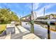 Dock features a boat lift and seating area by the water at 18753 Klingler Cir, Port Charlotte, FL 33948