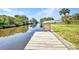 Private boat dock extends into the canal, offering direct access for boating and water activities at 18753 Klingler Cir, Port Charlotte, FL 33948
