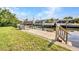 Well maintained backyard dock with railings, water access, and room for boat parking at 18753 Klingler Cir, Port Charlotte, FL 33948
