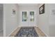 Inviting entryway featuring double doors with decorative glass and a patterned area rug on tile flooring at 18753 Klingler Cir, Port Charlotte, FL 33948