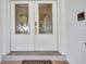 Elegant double front doors featuring ornate glasswork and polished hardware for a grand entrance at 18753 Klingler Cir, Port Charlotte, FL 33948