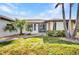 Attractive one-story home with a well-kept lawn and tropical landscaping, enhancing curb appeal at 18753 Klingler Cir, Port Charlotte, FL 33948