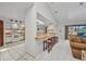 Bright kitchen featuring tiled flooring, modern appliances, and breakfast bar with seating at 18753 Klingler Cir, Port Charlotte, FL 33948