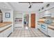 Bright kitchen with white cabinetry, light countertops, and tile flooring, offering ample storage and counter space at 18753 Klingler Cir, Port Charlotte, FL 33948
