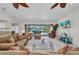 Spacious living room with comfortable furnishings, a large window, and a view of the pool at 18753 Klingler Cir, Port Charlotte, FL 33948
