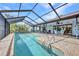 Inviting screened-in pool area perfect for relaxation, complete with a covered patio and comfortable seating at 18753 Klingler Cir, Port Charlotte, FL 33948