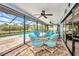 Enclosed lanai with dining set overlooking the pool and backyard, perfect for entertaining and relaxing at 18753 Klingler Cir, Port Charlotte, FL 33948