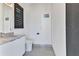 Modern bathroom with sleek vanity, toilet, large mirror and modern finishes at 19 Sabal Dr, Punta Gorda, FL 33950