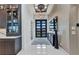 Grand entryway with marble floors, modern lighting, and a stylish bar area leading into a luxurious home at 19 Sabal Dr, Punta Gorda, FL 33950