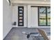 Modern home exterior featuring a black door, sliding glass doors, and tiled patio near the water at 19 Sabal Dr, Punta Gorda, FL 33950
