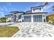 Beautiful home featuring a desert landscaped lawn, paved driveway, an attached two car garage, and a covered porch at 19 Sabal Dr, Punta Gorda, FL 33950