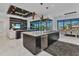 The gourmet kitchen features a large island and seamlessly transitions to the living and dining areas at 19 Sabal Dr, Punta Gorda, FL 33950