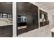 Sleek modern kitchen with stainless appliances and dark cabinets, opens into a bar area to create an impressive space at 19 Sabal Dr, Punta Gorda, FL 33950