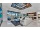 Spacious living room with a decorative ceiling, modern furnishings, and expansive windows offering water views at 19 Sabal Dr, Punta Gorda, FL 33950