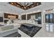 A stylish living room features a sleek ceiling design and flows into an open floorplan and the kitchen area at 19 Sabal Dr, Punta Gorda, FL 33950