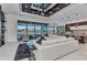 Bright living room features modern decor, tray ceiling, and large sliding glass doors to outdoor living space at 19 Sabal Dr, Punta Gorda, FL 33950