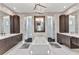 Bright bathroom with a soaking tub, dual vanities, and custom cabinetry at 19 Sabal Dr, Punta Gorda, FL 33950