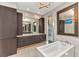 Light and airy primary bathroom featuring a soaking tub, a large vanity, and tile flooring at 19 Sabal Dr, Punta Gorda, FL 33950