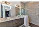 Modern bathroom features a dual sink vanity, a glass shower, and sleek fixtures at 19 Sabal Dr, Punta Gorda, FL 33950