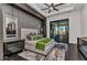 Modern bedroom with dark wood floors, a king-size bed, an accent wall, and glass doors to the lanai at 19 Sabal Dr, Punta Gorda, FL 33950