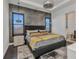 A well-designed main bedroom features modern decor, sconces, and natural light at 19 Sabal Dr, Punta Gorda, FL 33950